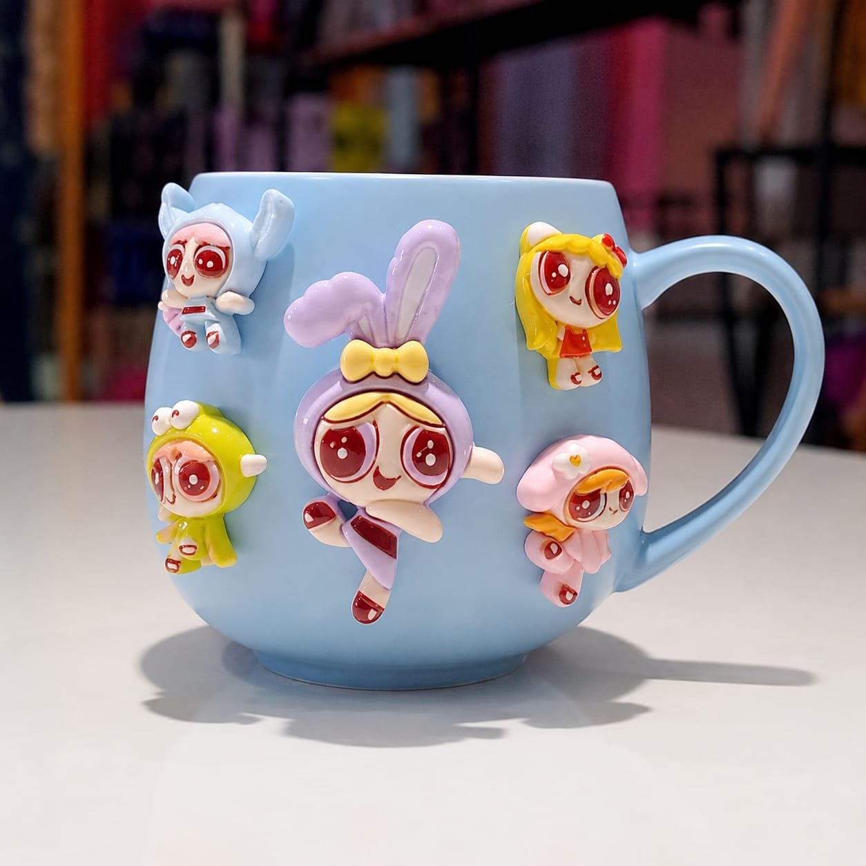 Blue ceramic mug features 3D polymer clay charms of  Powerpuff Girls.