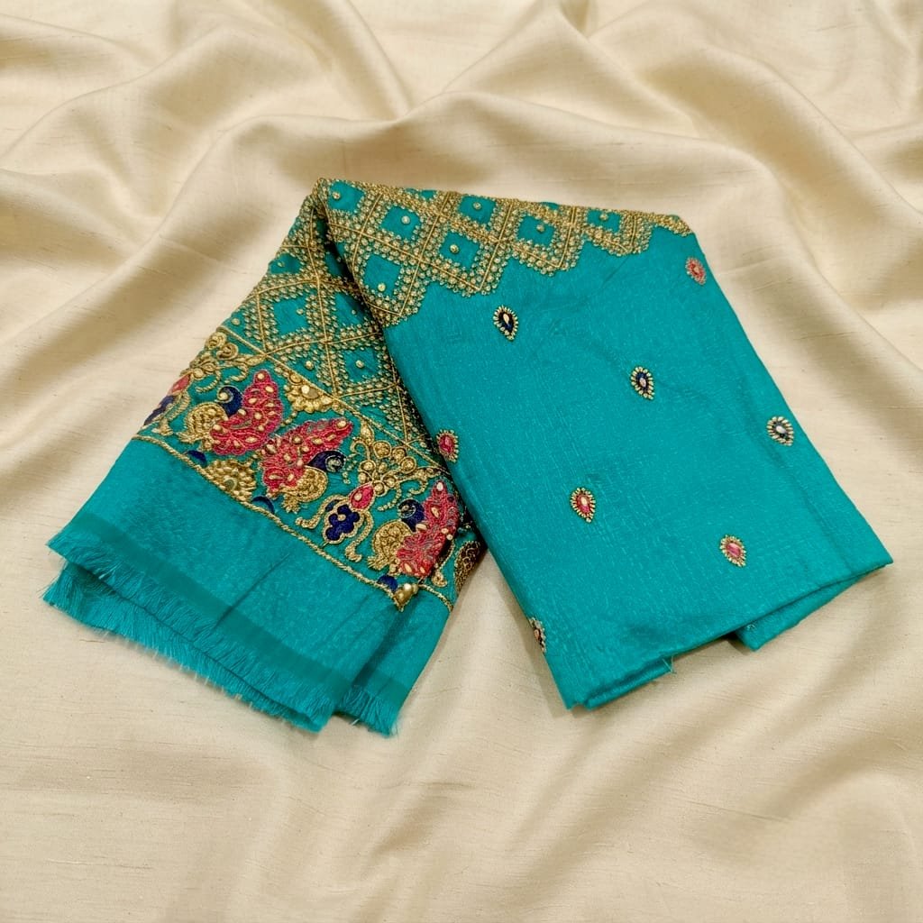 Teal green unstitched blouse fabric features intricate handwork embroidery with zari and beads.