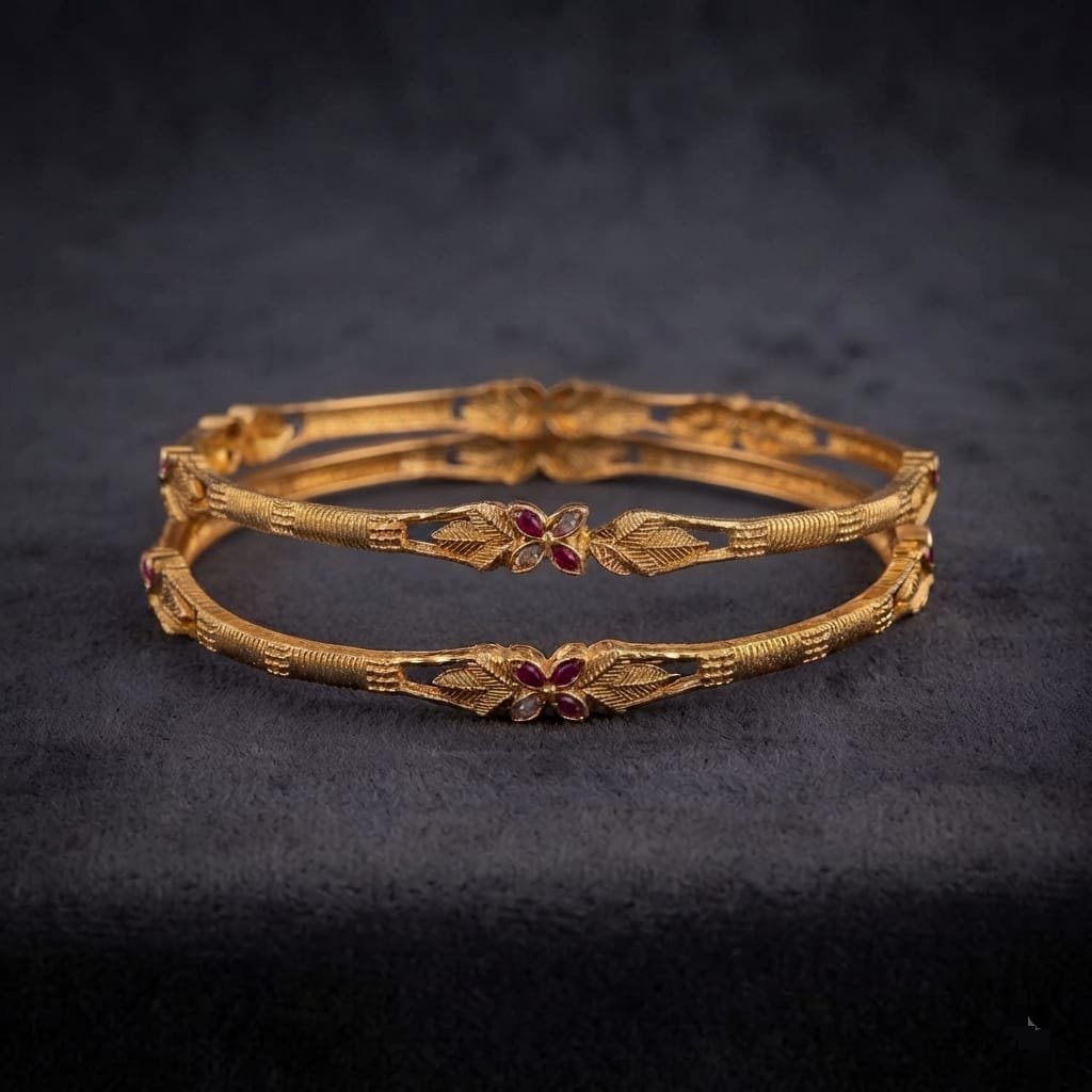 Imitation bangles intricately adorned with ruby-colored artificial stone accent.