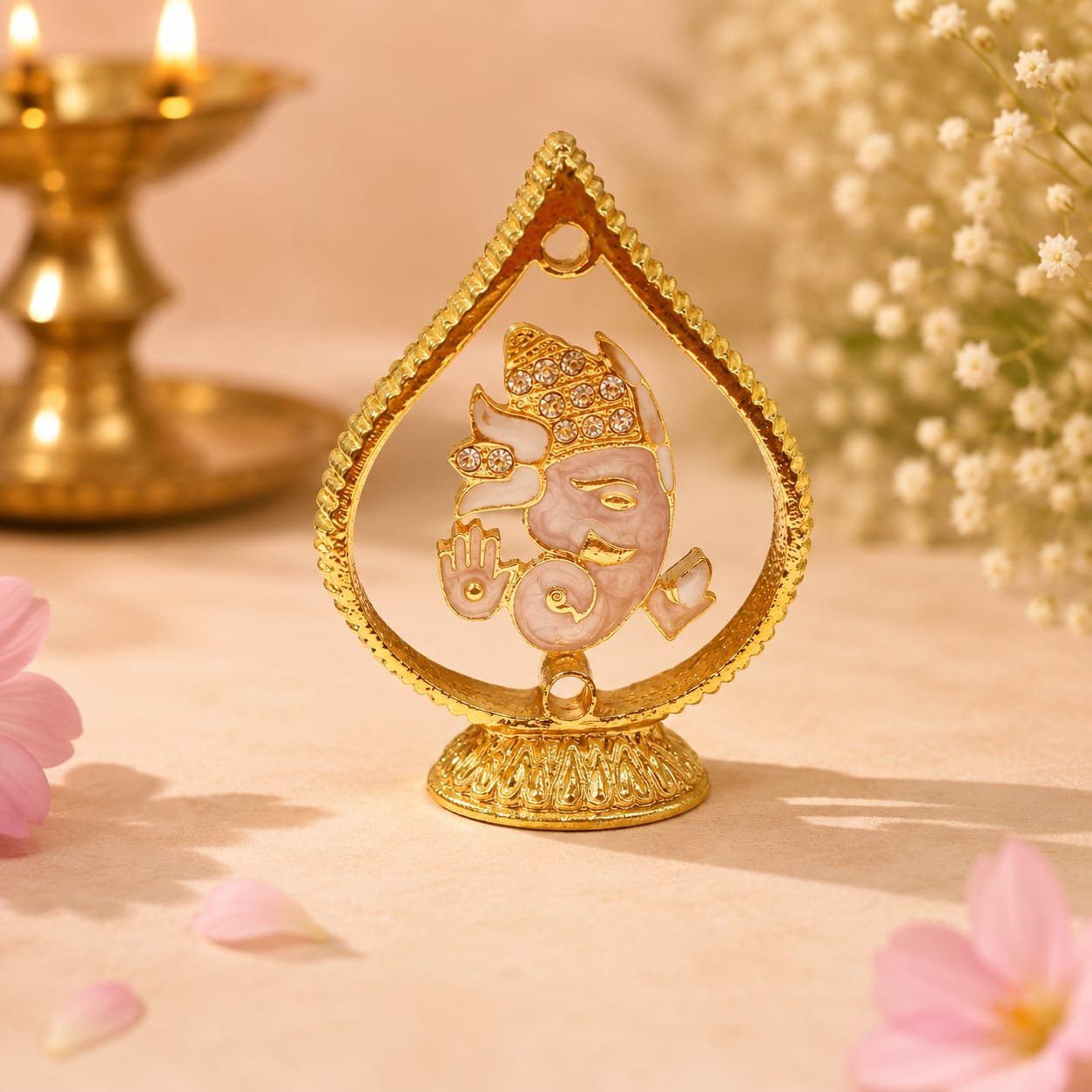 Gold-finished, rhinestone-studded Lord Ganesha.