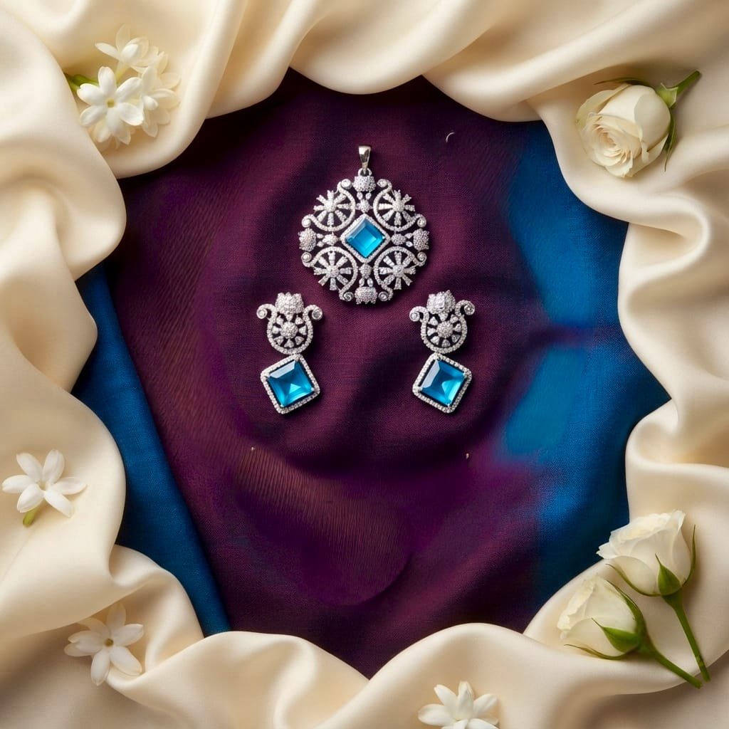 Elegant silver-tone jewelry set consisting of a matching circular pendant and a pair of drop earrings.